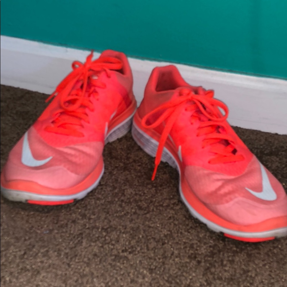 Neon orange Nike free runs